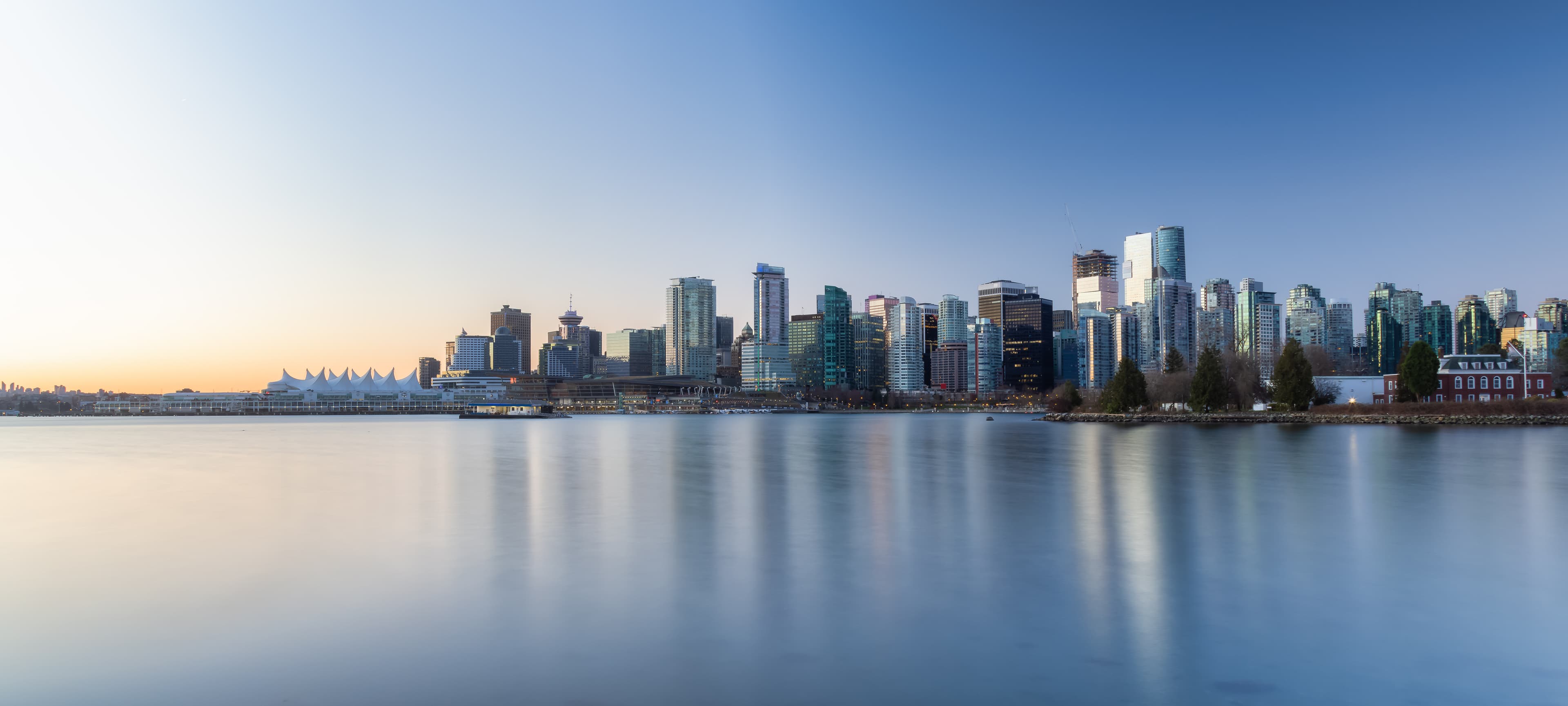 Waterfront city skyline at blue hour.